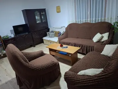 a living room with two couches and a coffee table at Domaćinstvo Drenak - Bešnjaja in Kragujevac