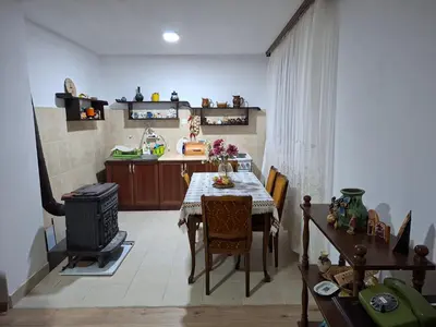 a kitchen with a table and a stove in it at Domaćinstvo Drenak - Bešnjaja in Kragujevac