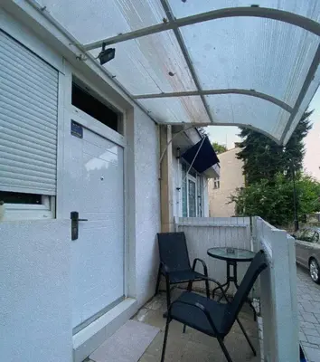 a patio with two chairs and a table on a porch at ---Apartmani Radosavljevic--- in Vrnjačka Banja