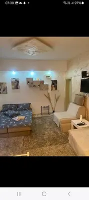 a living room with two beds and a tv at ---Apartmani Radosavljevic--- in Vrnjačka Banja
