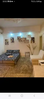a living room with a bed and a couch at ---Apartmani Radosavljevic--- in Vrnjačka Banja