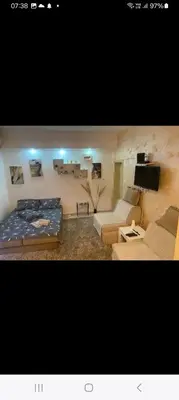 a living room with a bed and a couch at ---Apartmani Radosavljevic--- in Vrnjačka Banja