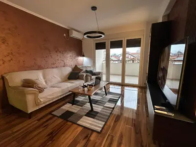a living room with a couch and a table at Apartman Petruska Park in Paraćin