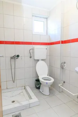 a bathroom with a toilet and a shower and a sink at Studio Merlin 4 in Soko Banja