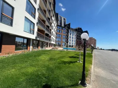 a street light in the grass next to a building at Lyra Prestige Residence Hill in Kopaonik