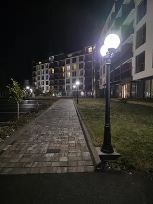 a street light on a sidewalk at night at Lyra Prestige Residence Hill in Kopaonik