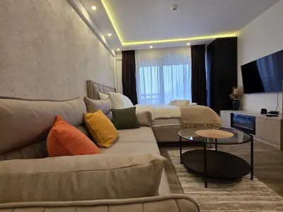 a living room with two couches and a tv at Lyra Prestige Residence Hill in Kopaonik