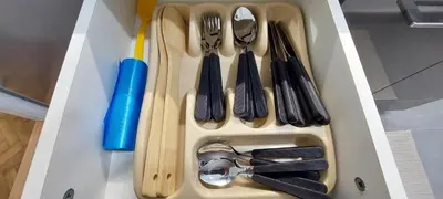 a drawer with utensils in a white box at 3M Lux Niš in Niš