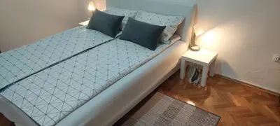 a bed with two pillows on it in a room at 3M Lux Niš in Niš