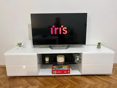 a white entertainment center with a flat screen tv at 3M Lux Niš in Niš