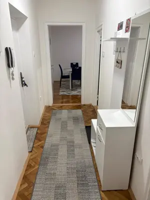 a hallway with a table and a dining room at 3M Lux Niš in Niš