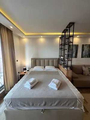a bedroom with a large bed with two towels at Residence Hill A42 in Kopaonik