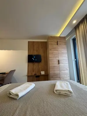 a bedroom with a bed with two towels on it at Residence Hill A42 in Kopaonik
