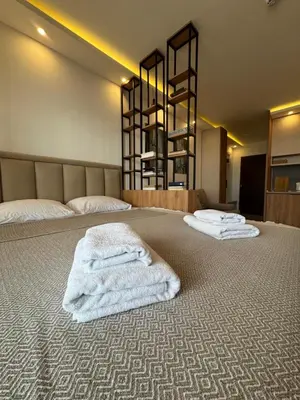 a bedroom with two white towels on a bed at Residence Hill A42 in Kopaonik