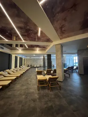 a dining room with chairs and tables and a ceiling at Residence Hill A42 in Kopaonik