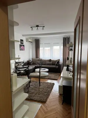 a living room with a couch and a table at bozicapartments in Jagodina