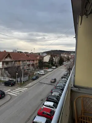 a view of a parking lot with cars parked on a street at bozicapartments in Jagodina