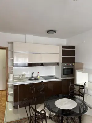 a kitchen with a sink and a table and chairs at bozicapartments in Jagodina