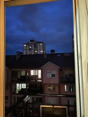 a view from a window of a building at night at Stan in Niš