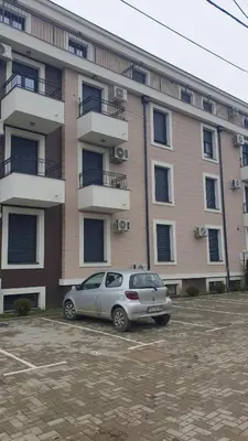 a car parked in a parking lot in front of a building at Apartman Boki X in Vrnjačka Banja