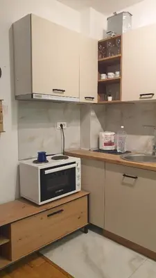 a kitchen with a microwave on top of a counter at Apartman Boki X in Vrnjačka Banja