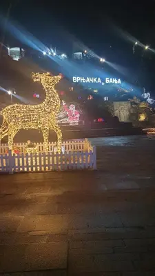 a statue of a horse is lit up at night at Apartman Boki X in Vrnjačka Banja