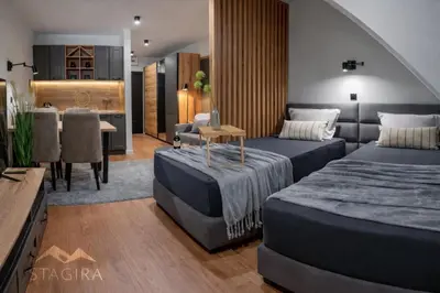 a living room with two beds and a dining room at Apartman Stagira - Bela Reka Gondola, Kopaonik in Brzeće