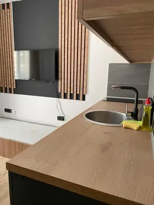 a kitchen with a sink and a wooden counter top at Mountain Soul - Residence Hill in Kopaonik