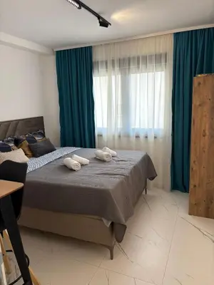 a bedroom with a bed with two towels on it at Nik 2 in Kruševac