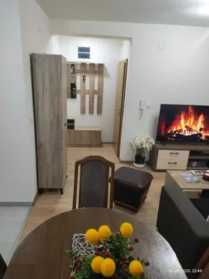 a living room with a table and a fireplace at Apartman Novak in Trnava
