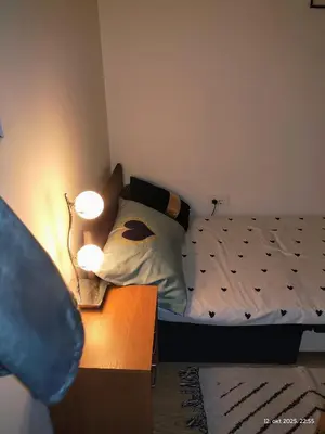 a bedroom with a bed and two lights on a table at Apartman Novak in Trnava
