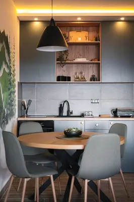 a kitchen with a wooden table and chairs at Hillview B117 in Kopaonik