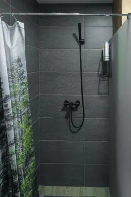 a bathroom with a shower with a shower curtain at Hillview B117 in Kopaonik