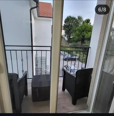 a balcony with chairs and a view of a parking lot at Apartmani Vrnjacka Banja 8 in Vrnjci