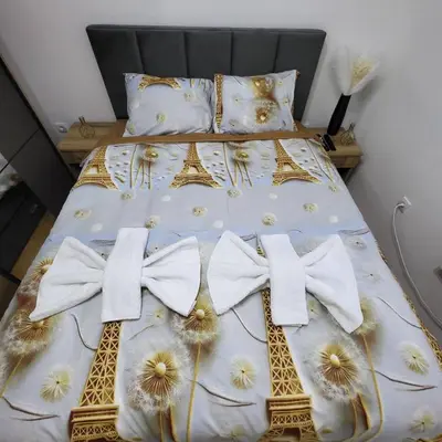 a bed with bows and flowers on it at Apartmani Vrnjacka Banja 8 in Vrnjci