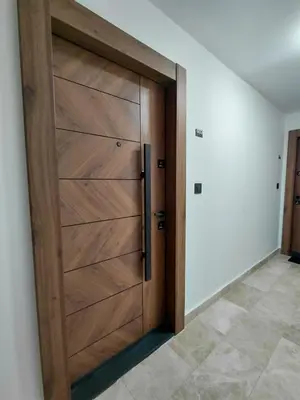 a wooden door in a room with a tile floor at DragonVB in Vrnjačka Banja