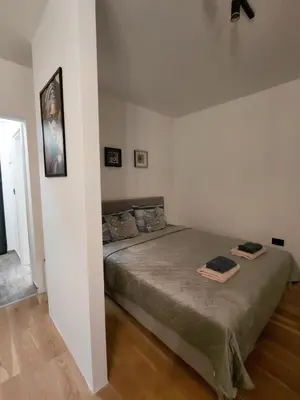 a bedroom with a bed with two towels on it at DragonVB in Vrnjačka Banja
