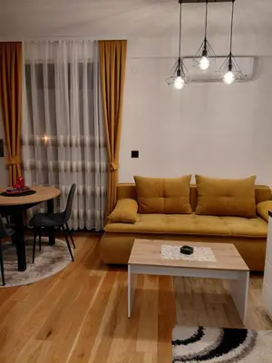 a living room with a couch and a table at DragonVB in Vrnjačka Banja