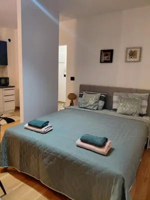 a bedroom with a large bed with two towels on it at DragonVB in Vrnjačka Banja
