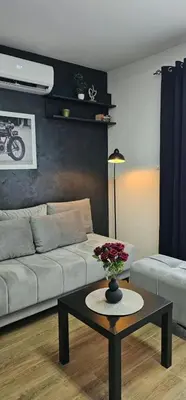 a living room with a couch and a table at Luna Apartmani in Soko Banja