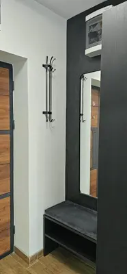 a room with a mirror and a black and white wall at Luna Apartmani in Soko Banja