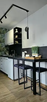 a kitchen with a table and some chairs at Luna Apartmani in Soko Banja