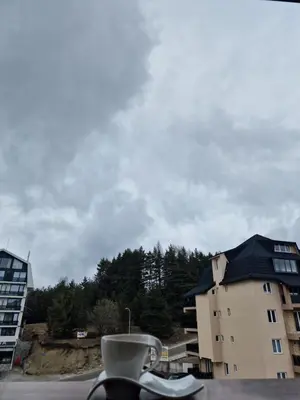 a cup of coffee sitting on top of a building at Whisper apartments Kopaonik in Kopaonik