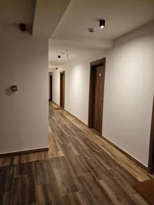 an empty room with white walls and wooden floors at Whisper apartments Kopaonik in Kopaonik