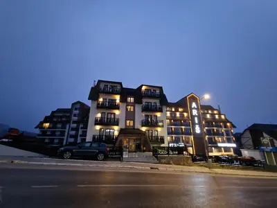 a building with a car parked in front of it at Whisper apartments Kopaonik in Kopaonik