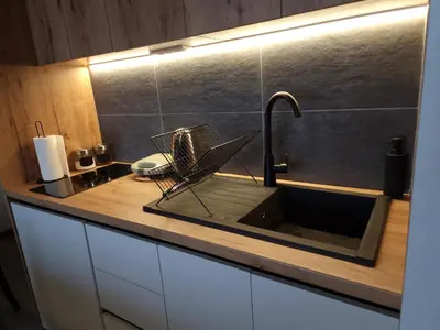 a kitchen counter with a sink and a faucet at Whisper apartments Kopaonik in Kopaonik