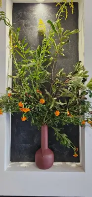 a plant in a red vase on a shelf at Elegant 406 Family Apartment in Vrnjačka Banja