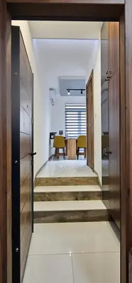 a hallway with stairs leading to a dining room at Elegant 406 Family Apartment in Vrnjačka Banja