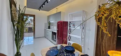 a kitchen with a table and a red refrigerator at Elegant 406 Family Apartment in Vrnjačka Banja