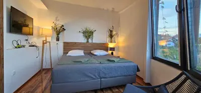 a small bedroom with a bed and a window at Elegant 406 Family Apartment in Vrnjačka Banja